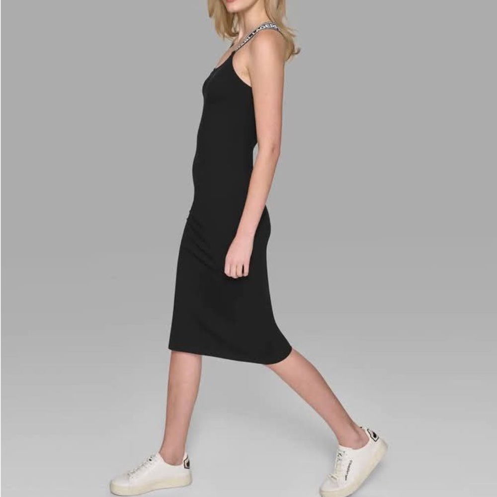 Karl Lagerfeld. The dress is white. The one model is wearing is the same style.